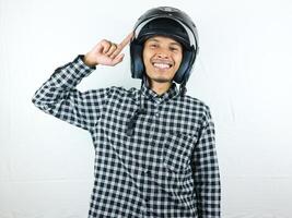 Portrait Asian man holding motorcycle helmet with excited expression. Safety riding. photo