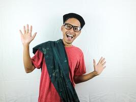 funny expression happy asian man wearing sarong, glasses and cap photo