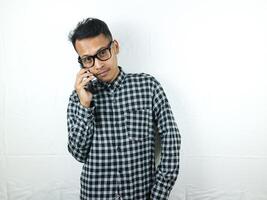 Portrait of asian man talking on phone with smiling face expression. photo