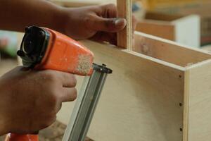 carpenter measuring, cutting, sanding wooden in workshop photo