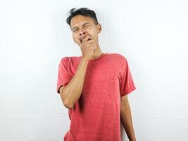 Tired asian man with yawn face expression, sleepy and back pain on white background photo