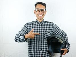 Portrait Asian man holding motorcycle helmet with excited expression. Safety riding. photo