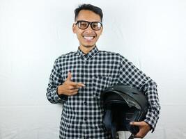 Portrait Asian man holding motorcycle helmet with excited expression. Safety riding. photo