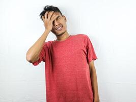 Tired asian man with yawn face expression, sleepy and back pain on white background photo