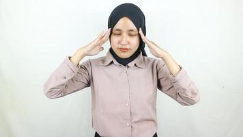 Portrait Asian Muslim woman doing stress and headache expression. photo