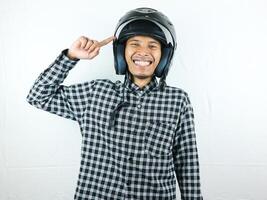 Portrait Asian man holding motorcycle helmet with excited expression. Safety riding. photo