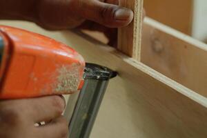 carpenter measuring, cutting, sanding wooden in workshop photo