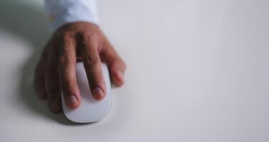 Close up of hand using on white mouse and clicking on office table photo