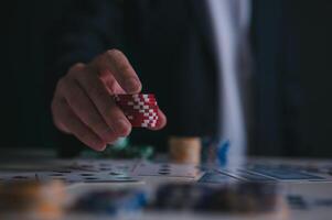 a man or poker player stack and put chips on table in concept of casino gambling all in photo