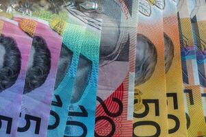 Finance and saving Australian dollar notes as background. Color AUD banknotes. photo