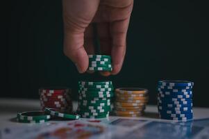 a man or poker player stack chips on table in concept of casino gambling all in photo