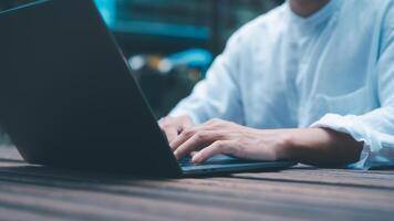 a businessman or freelancer using computer laptop sitting on table outside working on business or internet online marketing photo