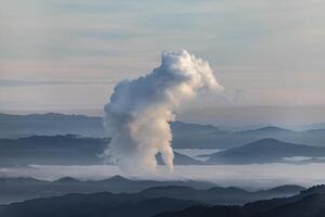 Beautiful morning scenery with fog in the background at Mae Moh Lignite Coal Power Plant, Lampang, Thailand Industrial white vapor from cooling and tower pipes, industrial and environmental themes photo