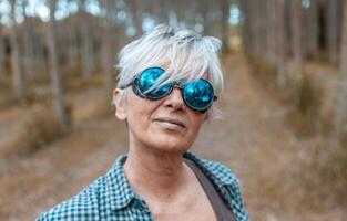 portrait of beautiful mature lumberjack woman with sunglasses photo