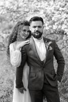 a bearded groom and a girl with green hair are walking photo