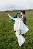 a bearded groom and a girl with green hair dance and twirl photo