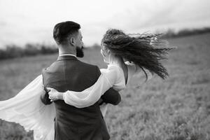 a bearded groom and a girl with green hair dance and twirl photo