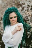 young girl bride with green hair in a national dress photo