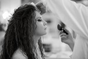 portrait of a bride with green curly hair in the beauty room photo