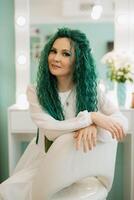 portrait of a bride with green curly hair in the beauty room photo