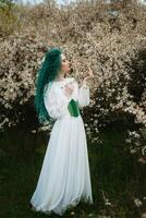 young girl bride with green hair in a national dress photo