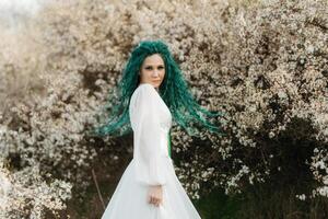 young girl bride with green hair in a national dress photo