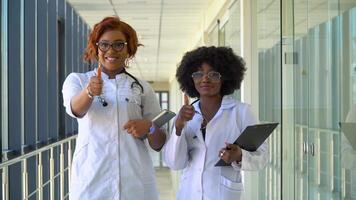 Close up of two african american doctors in hospital looking at the camera video