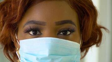 Close up of african american doctor in protective mask. Covid-19 protection video