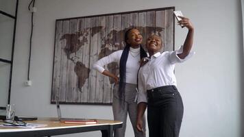 Two happy african american business partners makes selfie video