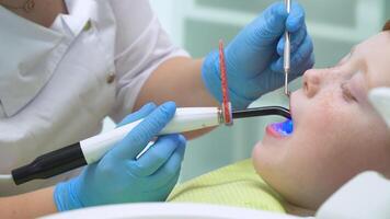 Little boy at reception at dentist in dental chair. Pediatric dentistry video