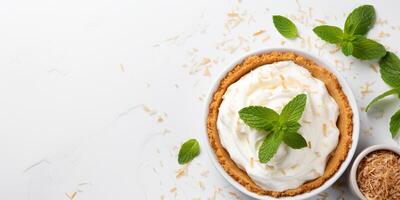 AI generated Top view of coconut cream pie garnished with mint leaves on white background with copy space Delicious fresh baked healthy dessert photo