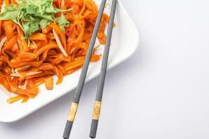 Pad Thai on a dish isolated on a white background. Top view. Thai foods famous. photo