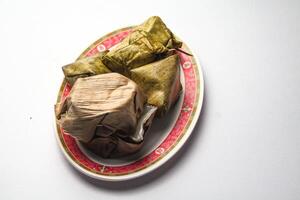 Stuffed Dough Pyramid Dessert and Nian Gao or Chinese new year's rice cake on Chinese style plate photo