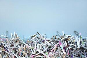 The shredded paper on light blue background. photo