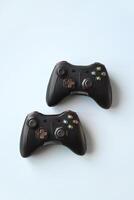 Two joystick gaming controller on light blue background. Minimalism. photo