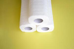 Absorbent paper napkin kitchen towels on yellow background. photo