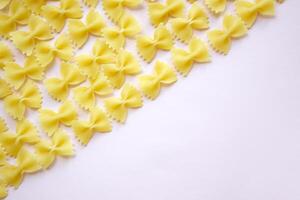 There are a lot of butterfly-shaped pasta on the table. photo