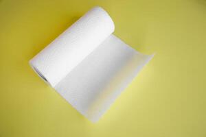 Absorbent paper napkin kitchen towels on yellow background. photo