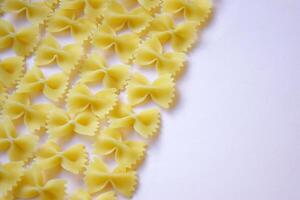 There are a lot of butterfly-shaped pasta on the table. photo