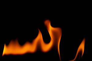 Hot flames on a black background. Beautiful flame of fire in the dark. Abstract of burning flames and smoke. photo