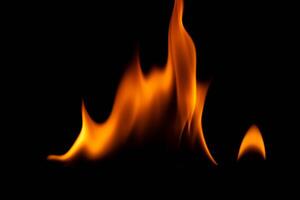 Hot flames on a black background. Beautiful flame of fire in the dark. Abstract of burning flames and smoke. photo