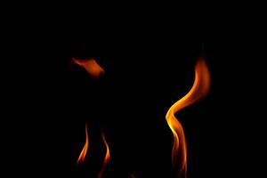 Hot flames on a black background. Beautiful flame of fire in the dark. Abstract of burning flames and smoke. photo