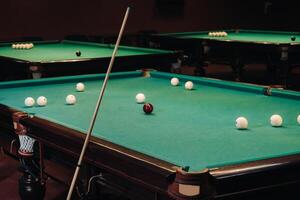 Billiard table with green surface and balls in the billiard club.Pool Game photo