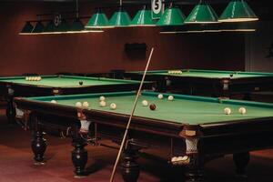 Billiard table with green surface and balls in the billiard club.Pool Game photo