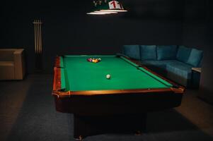 Billiard table with green surface and balls in the billiard club.Pool Game photo