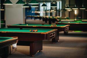 Billiard table with green surface and balls in the billiard club.Pool Game photo