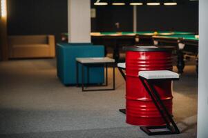 table and two chairs near the green-covered billiard table with balls in the billiard club photo