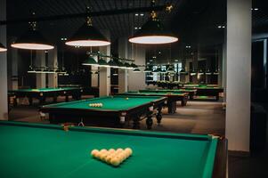 Billiard table with green surface and balls in the billiard club. photo