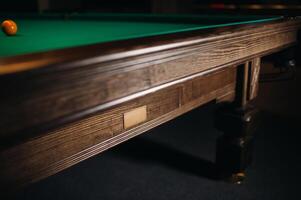 The oak decorative leg of a billiard table looks expensive photo