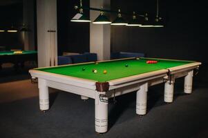 placing snooker balls on a green billiard table photo